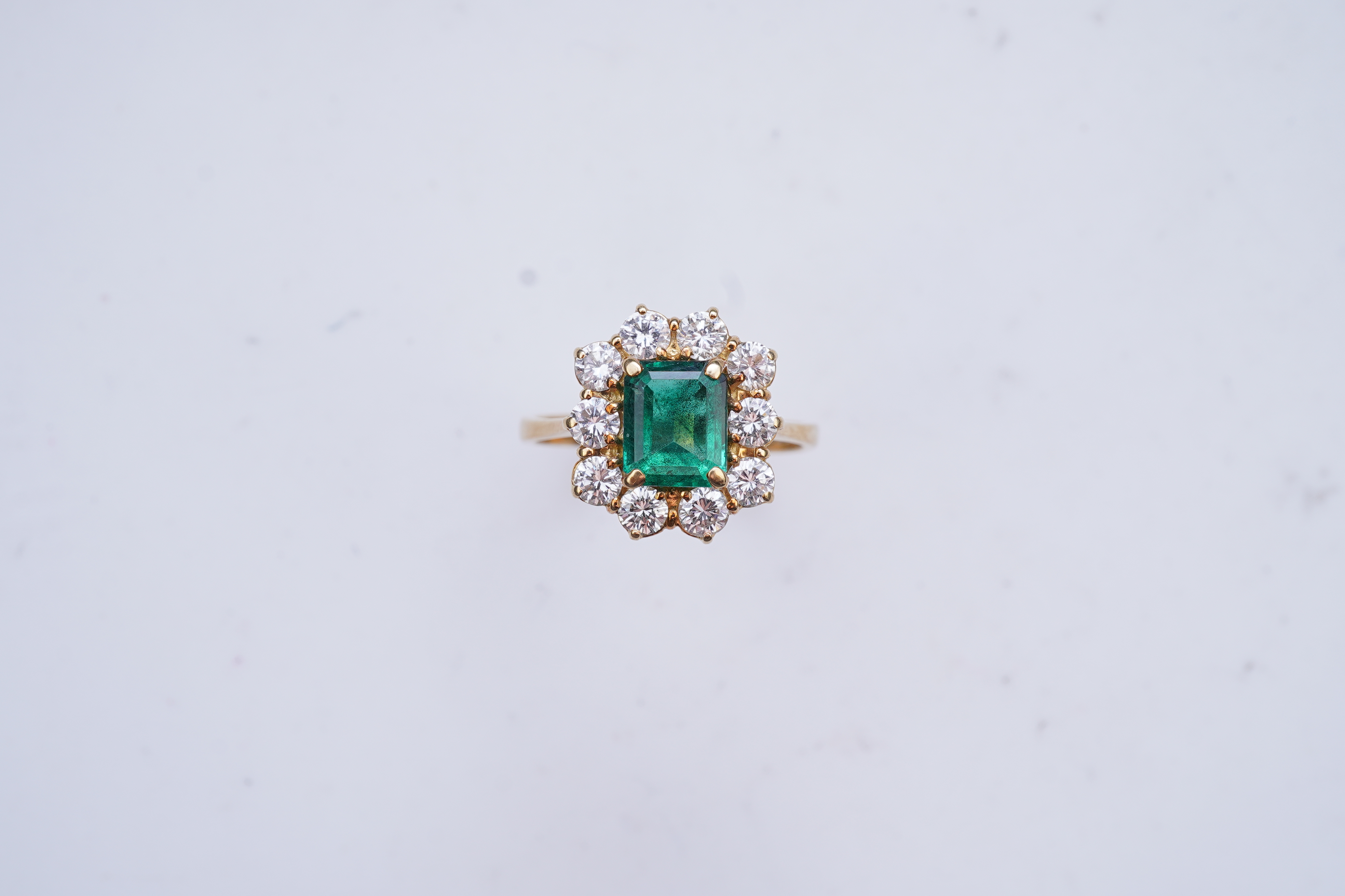 A synthetic emerald and diamond ring